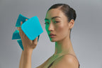 Model holding Blue Green Mask Lift with green light on
