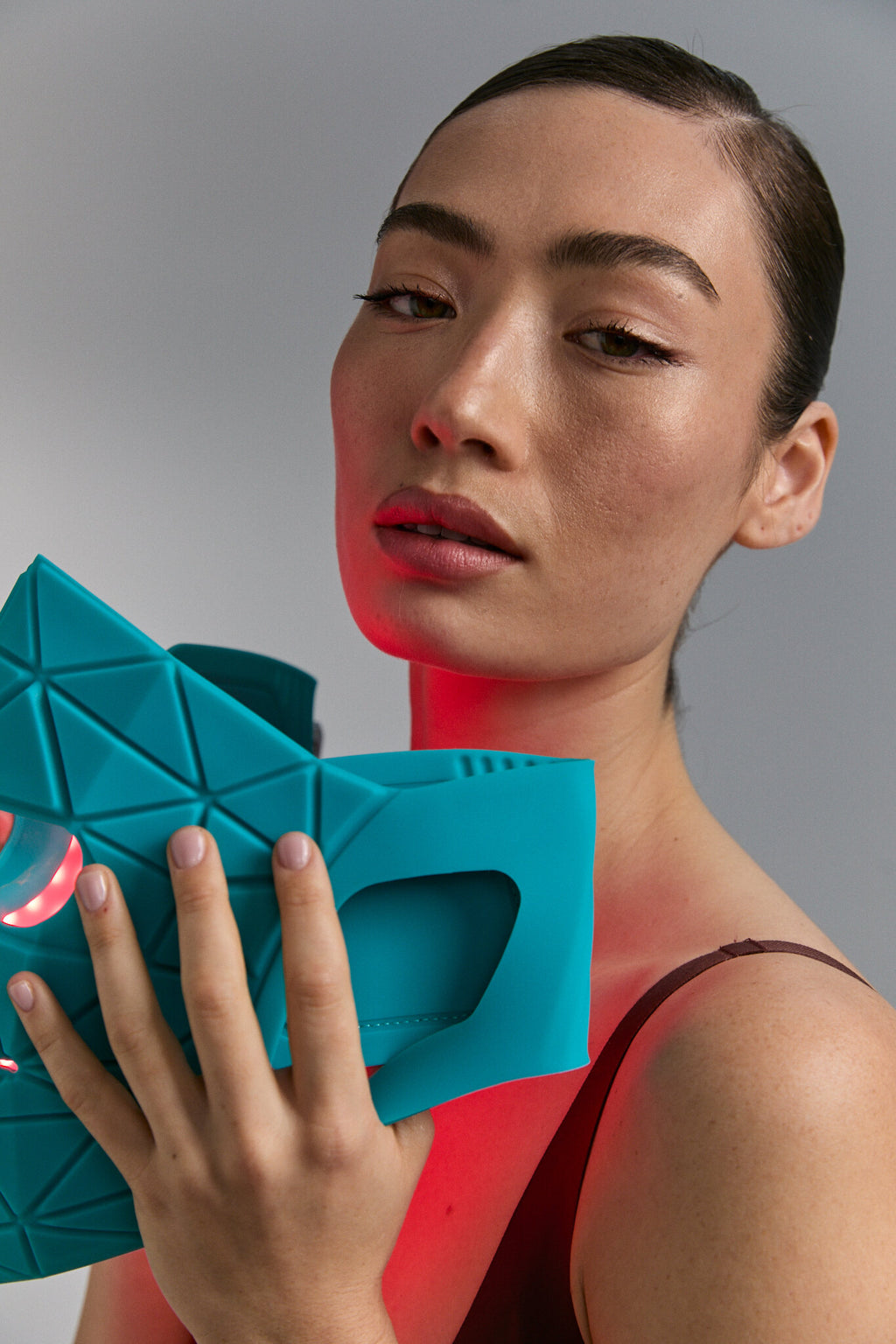 Close-up of Blue Green Mask Lift against the face