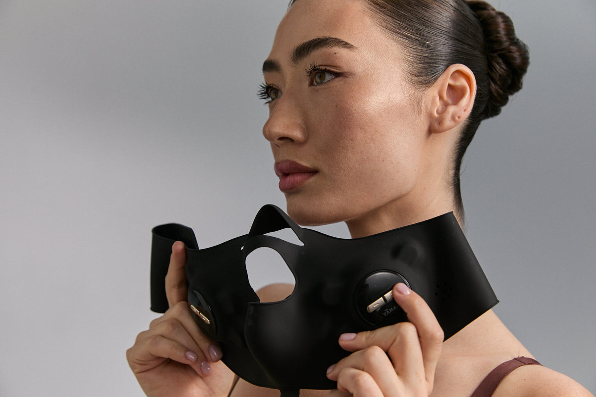 Model holding Medi Lift Plus mask at her jaw, landscape view