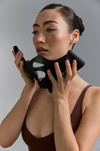 Model holding Medi Lift Plus mask to her cheeks