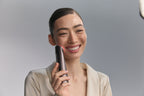 Smiling model holding Photo Plus Deep Lift