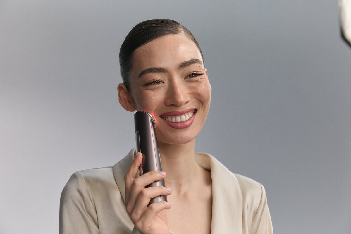 Smiling model holding Photo Plus Deep Lift