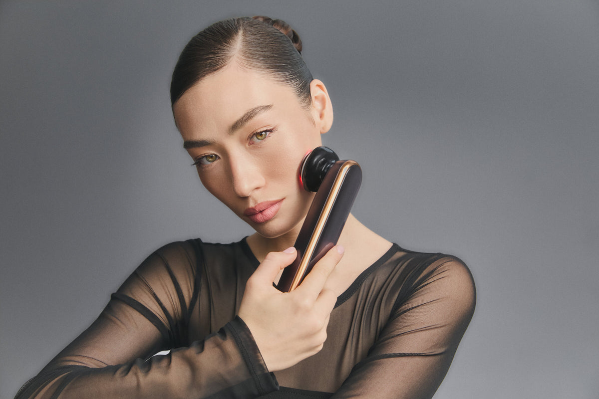 Model holding Photo Plus Prestige SP III to her cheek, red light on