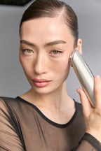 Model holding Photo Plus Shiny Neo to her cheek